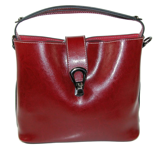 A glossy burgundy leather handbag with a top handle and a black metal clasp closure, set against a plain white background.