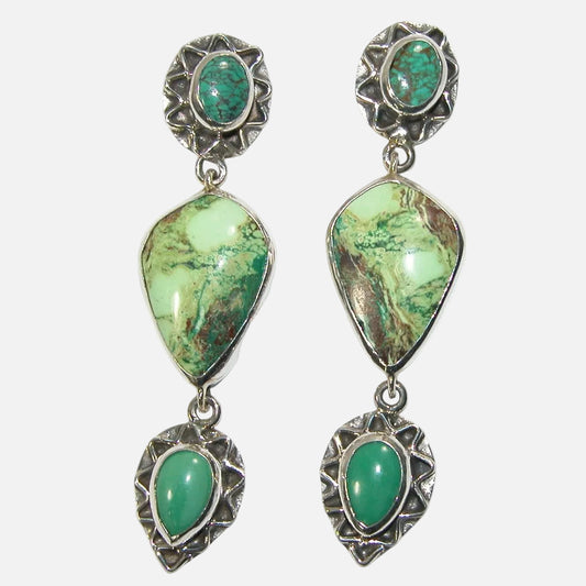 Pair of earrings with turquoise and gaspitite gemstones and sterling silver detailing on a white smoke background